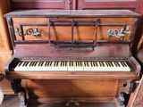 a piano that is sitting in the corner of a room