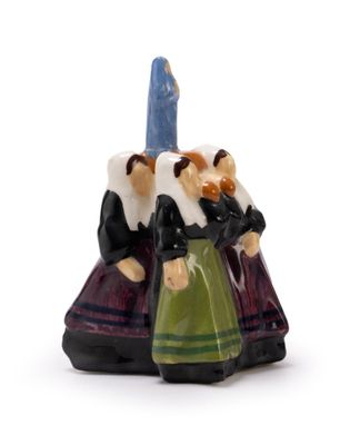 a small figurine of two people holding a candle
