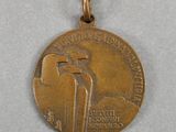 a close up of a medal on a white surface