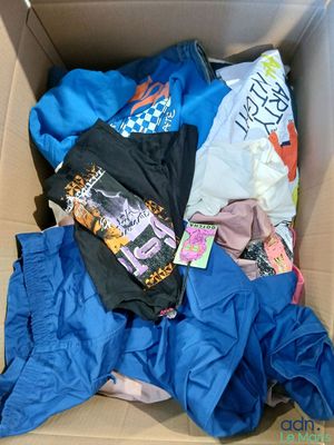 a cardboard box filled with clothing and clothing items