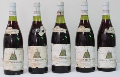 six bottles of wine are lined up in a row on a white surface