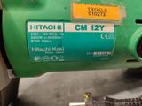 a close up of a green machine with a sticker on it