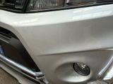 a close up of the front bumper of a white car