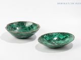 pair of green marbled bowls on a white surface