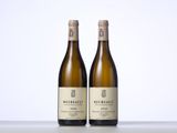 two bottles of wine sitting on top of a table next to each other