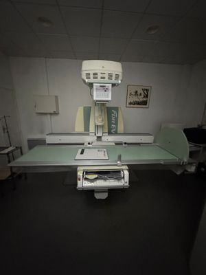 a medical room with a large machine in the middle of the room