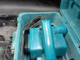 a blue tool in a blue case on the ground