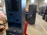 a picture of a machine in a warehouse with a hand truck