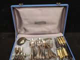 a blue case with silverware in it on a black surface