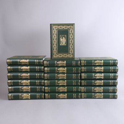 several green books stacked on top of each other on a white surface