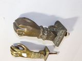 a pair of brass hands that are next to a pair of scissors