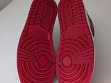 a pair of red shoes on a white surface
