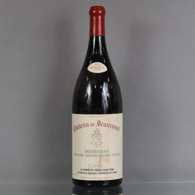 a bottle of red wine sitting on top of a glass table