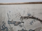 a painting on the wall of a room with a cat sitting on the floor