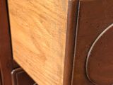 a close up of a wooden cabinet with a metal knob