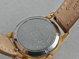 someone is holding a watch with a leather strap around it