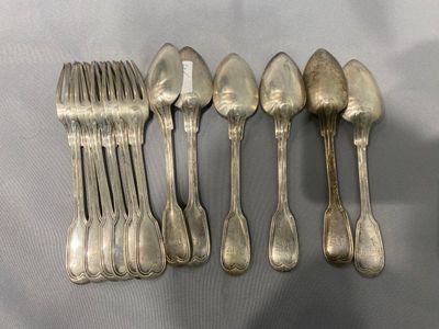 six cuillères et six fourchettes en argent sont alignées sur une table