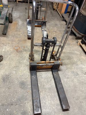 a fork lifter that is sitting in a garage