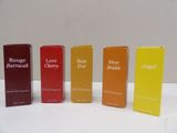 four different types of perfumes are lined up on a table