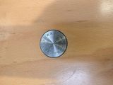 a close up of a knob on a wooden table