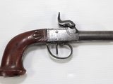 a close up of a gun on a white surface with a bird on it