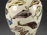 an image of a vase with fish painted on it