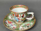 a close up of a cup and saucer on a table