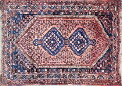 an antique persian rug with a blue and red design
