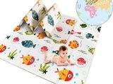 a close up of a baby laying on top of a map of the world