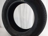 a close up of a tire on a white surface with a curtain in the background