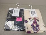 two pairs of women ' s pants are wrapped in plastic bags