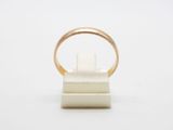 a close up of a gold ring on a white surface