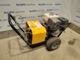 a close up of a small engine on a cart in front of a wall
