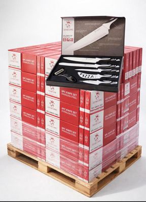 a stack of red boxes with a knife on top of it