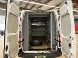 a white van with its doors open in a garage