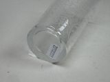 a glass with a label on it sitting on a table