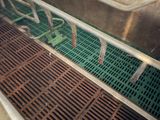 a metal grate on the floor next to a sink