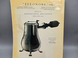 an old advertisement for a coffee maker on a table