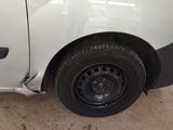a white van that has a flat tire on the side of it