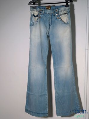 jeans hanging on a hanger in front of a white door