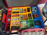 a red case filled with lots of assorted assorted items