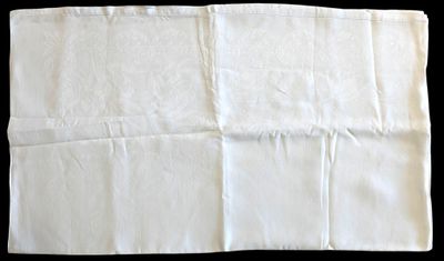 a piece of white paper folded on top of a black table