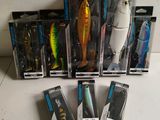 several different types of fishing lures are lined up on a table