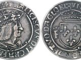 an image of a silver coin with a crown on it