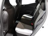 the back seats of a white car with a black seat belt