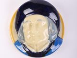 a blue and yellow plate with a picture of a man on it