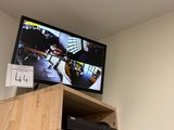 a television that is on top of a shelf in a room