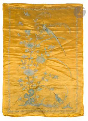 a yellow silk embroidered with a bird and flowers on it