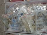 a plastic box filled with assorted items on the floor