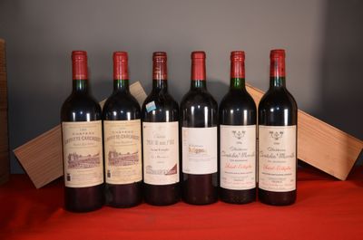 six bottles of red wine are lined up on a red table